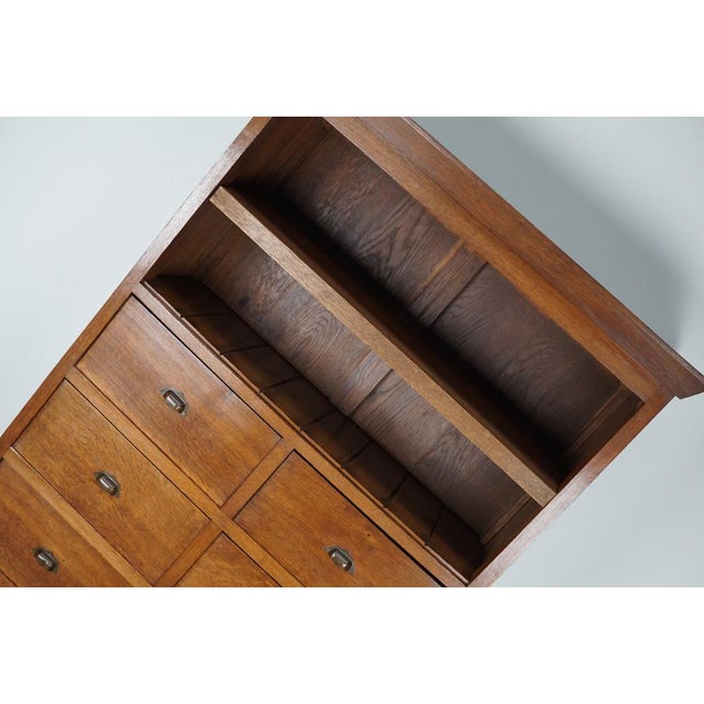 This unique filing cabinet / bank of drawers was designed and made around the 1920s in France. It was made from oak with...