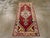 This vintage Turkish Oushak throw rug has a Caucasian air with its rich red field and stepped, medallion with equally...
