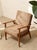 A handsome vintage armchair with a warm walnut frame and a classic mid-century silhouette. The clean, gently tapered legs...
