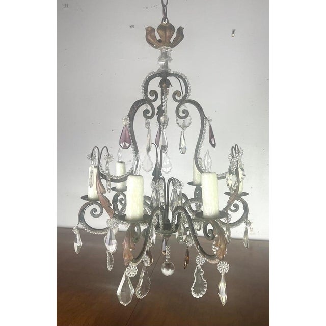 French ornate iron & crystal chandelier with a classic design. The ornate scrolling arms, candle-style lights, and...