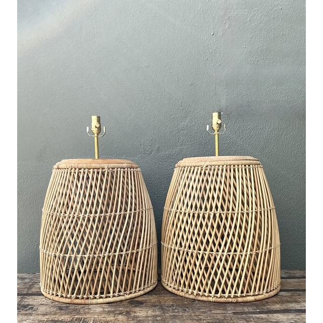 Infuse your living space with the warm, organic textures of this exceptional pair of vintage woven rattan table lamps....