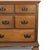 A generously scaled traditional wood dresser with nine drawers, bracket feet, framed drawer fronts, fluted corner details,...