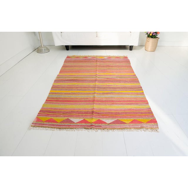 This is a vintage Turkish Oushak rug from the Mid 20th Century. The piece was hand-knotted.