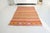 This is a vintage Turkish Oushak rug from the Mid 20th Century. The piece was hand-knotted.