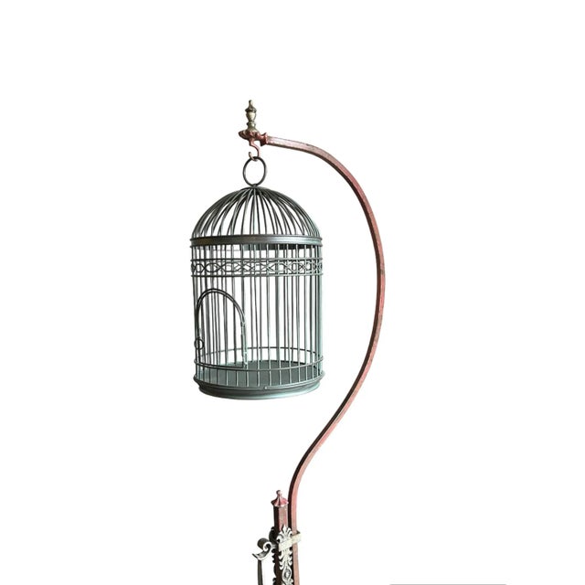 Wrought Iron hanging birdcage with adjustable stand. The stand is a distressed rust color, with a wrought iron silver/gray...