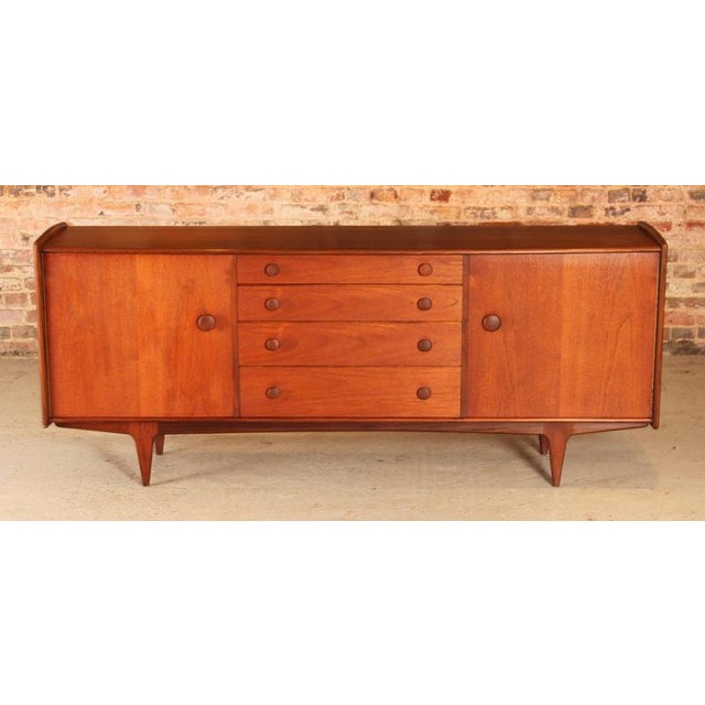 Mid century solid afromosia sideboard by a. Younger ltd, england, circa 1960s. 2 cabinet sections and 4 drawers, top...