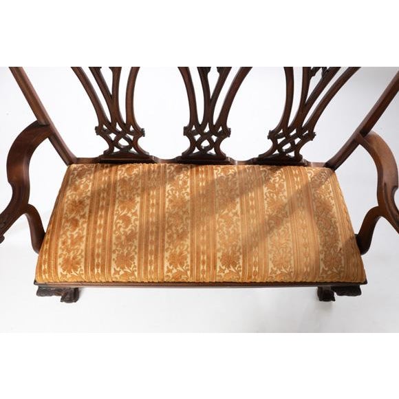 Mahogany carved Chippendale style ball and claw foot settee. Circa 1900