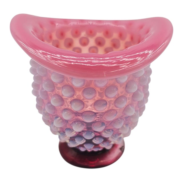 Like a giggle caught in glass, this little hat glows with mischief and sweetness. The wild rose hue runs through it like a...