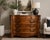 Classic bachelor chest / console reproduction piece in Louis Philippe style featuring ornate carvings on side pillars, an...