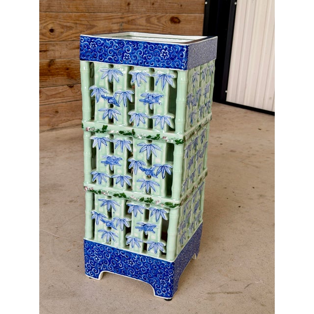 A striking large-scale glazed ceramic umbrella stand or jardinere featuring an intricately pierced faux bamboo lattice...