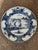 18th century Delft plate painted in blue and white with a central landscape scene showing a figure beneath a willow tree...