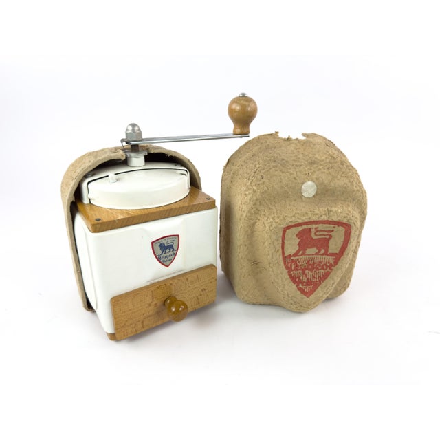 A beautifully preserved vintage French manual coffee grinder by Peugeot Frères, complete with its original protective...