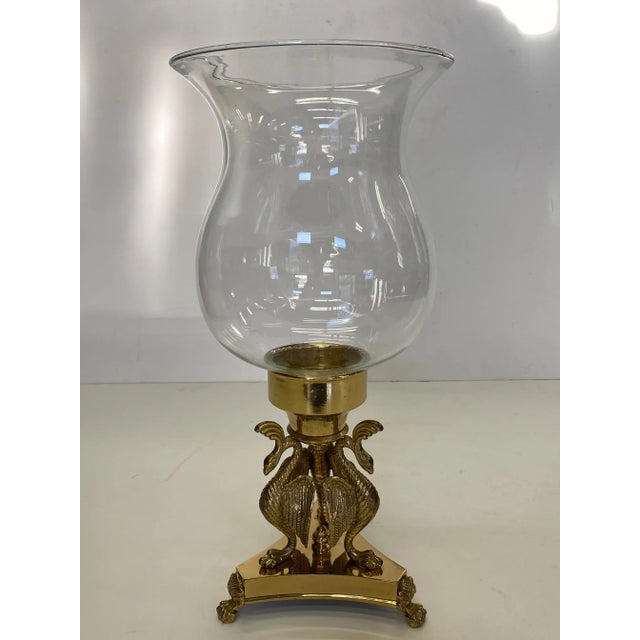 Stunning pair of blown glass hurricanes having whimsical solid brass bases with birds.