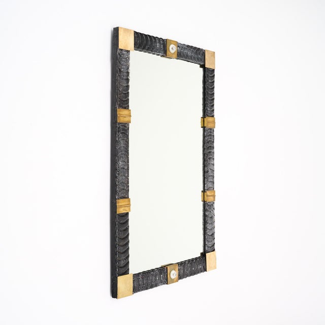 Rectangular mirror with a frame of textured Murano glass elements and brass. The glass sections are hand-blown glass in a...