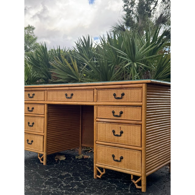 A beautiful vintage bamboo and rattan desk featuring classic coastal styling, woven rattan drawer fronts, and timeless...