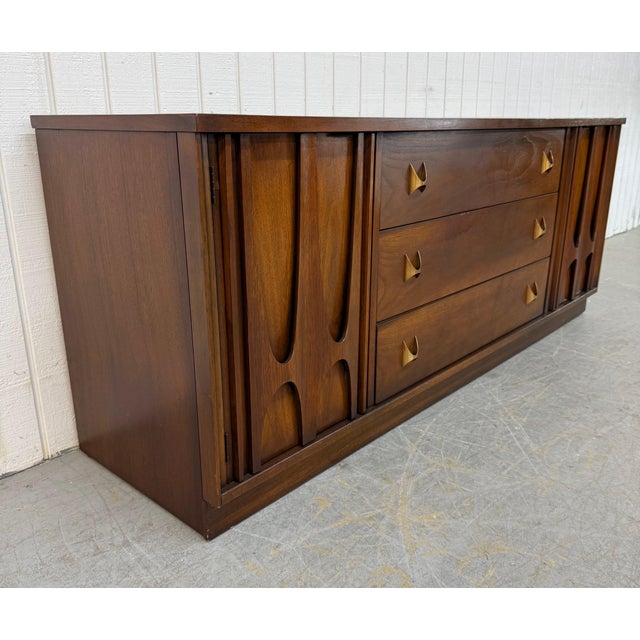This listing is for a Mid-Century Modern Broyhill Brasilia Sideboard. Featuring a straight line design, two doors with...