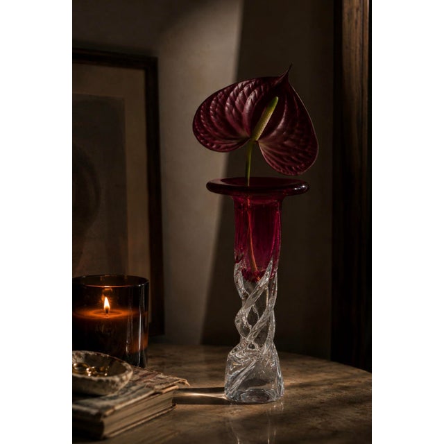 A stunning example of American hand – blown art glass featuring a bold cranberry, ruby trumpet flare a top a sculptural...