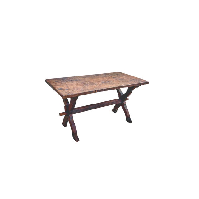 An antique, rustic tavern table, dating around 1900, with an X-shaped base. Handcrafted from dark oak and sturdily built....