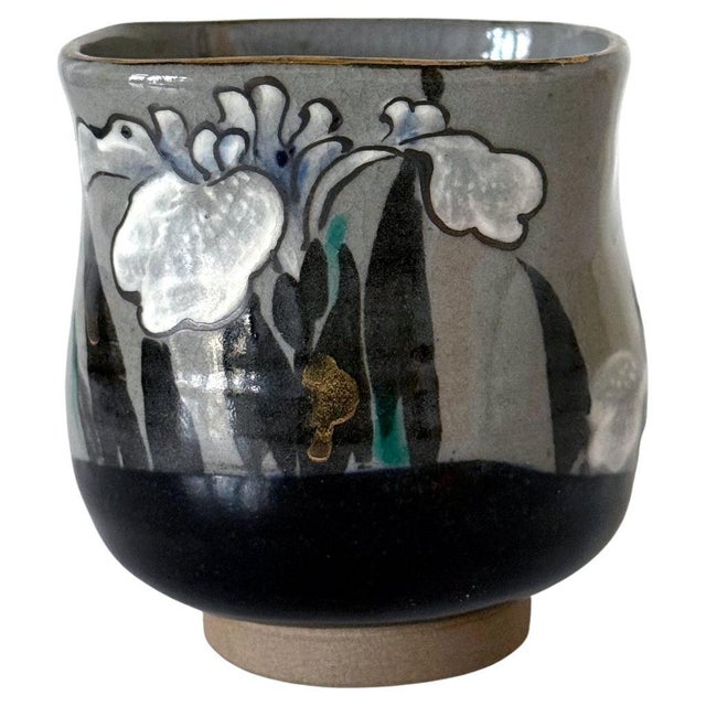 A small glazed ceramic teacup with surface paint decoration by Japanese imperial potter Makuzu Kozan ((1842–1916) with two...