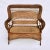 American Victorian wicker roll design high back loveseat with spindles and bobbins on the back and apron and cane seat....