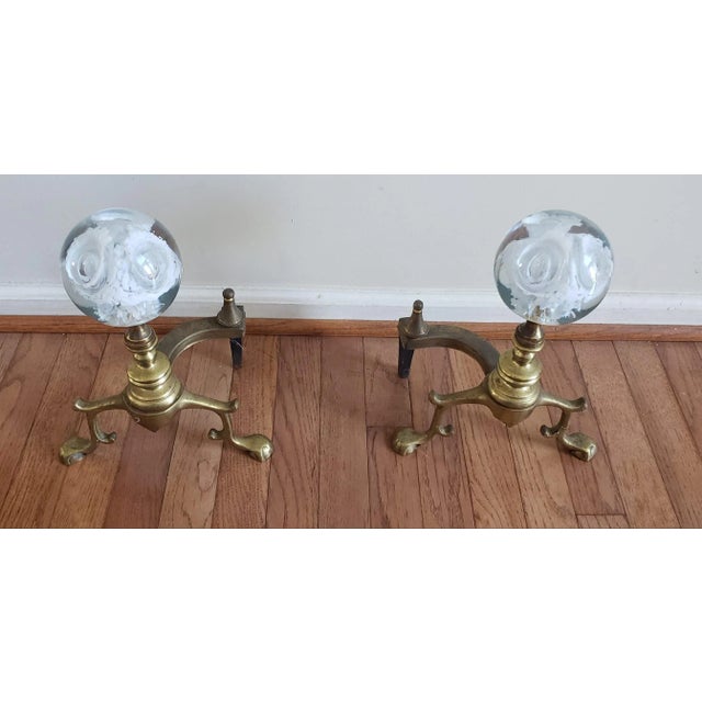 A Pair of Regency Brass & Murano Glass balls Andironss in very good vintage conditions. Measures 9.25" in width, 6.5" in...