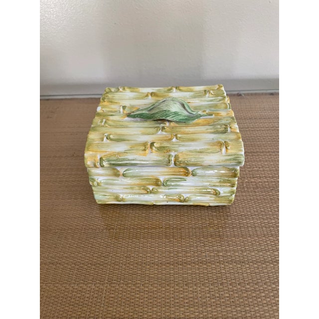 This 60’s era box is in the form of bamboo with a leaf as the top pull. It’s been glazed to mimic the natural colors of...