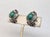 1960s sterling silver faux-jade bead center with metal loop surround with curls at the bottom on either side butterfly...