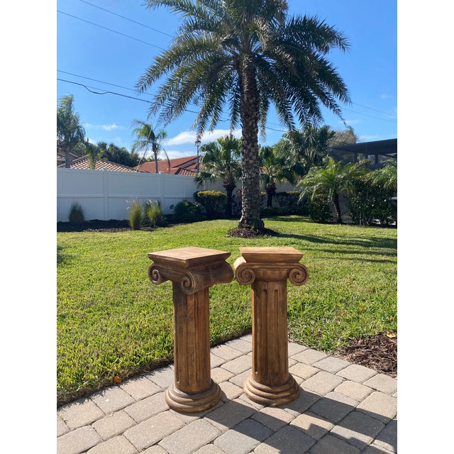 Pair of heavy wood ionic column side tables/pedestals. Entirely hand-carved from wood; super solid and sturdy. Great at...