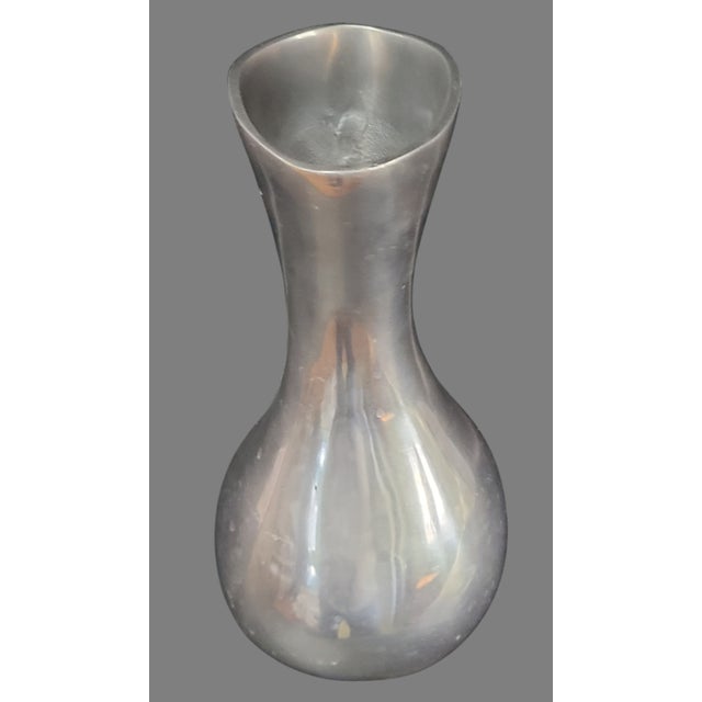 Crafted with a keen eye for design, this Mid-Century Modern Polished Aluminum Oval Shaped Vase is a testament to timeless...