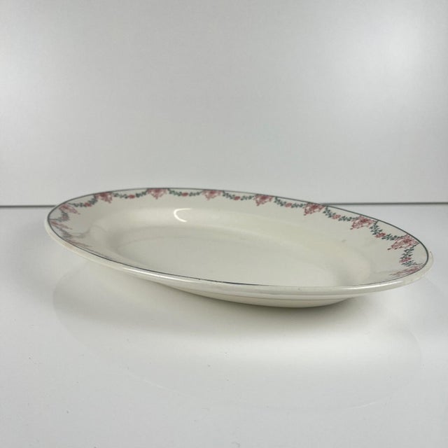 Longwy oval platter, pink and green garland motif, early 20th century. Dimensions: 37 x 25.5 cm Height: 4 cm Good overall...