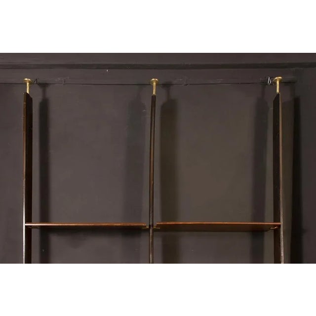 Remarkable bookcase with steel and brass details. Composed by two modules with 4 shelves, 3 drawers, 2 cabinets with doors...