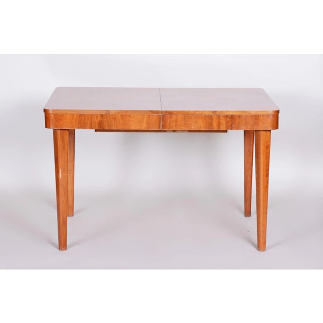 Art Deco table. Original condition Surface with piano lacquers to the high gloss. This piece is attributed to the...