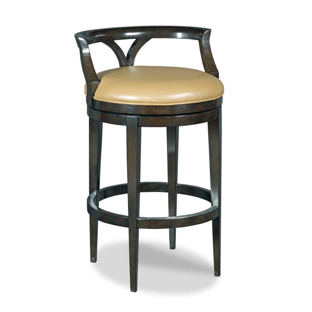 A curved back rests above an upholstered seat raised by tapering legs.