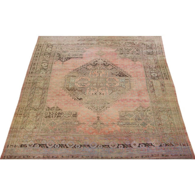 Beautiful Antique Oushak hand-knotted wool rug with a rose color field. This Piece has green, gray, and blue accent colors...