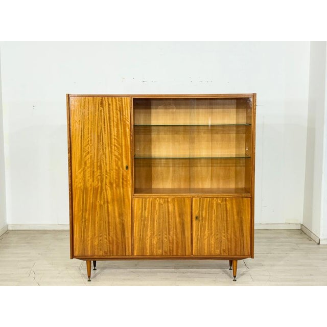 This elegant mid-century living room cabinet from the 1960s captivates with its exceptional walnut veneer featuring a...
