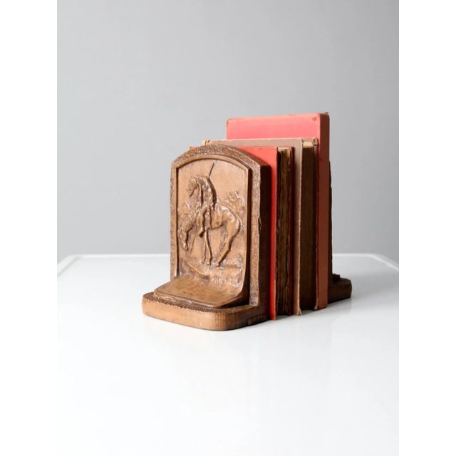 Pair of vintage 1930s chalkware bookends in a warm maple brown finish, modeled after End of the Trail by James Earle...