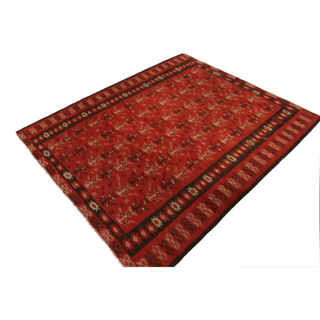 Handwoven in wool circa 1950-1960, a vintage tribal Kilim rug believed to hail from a rare Macedonian provenance. The rare...