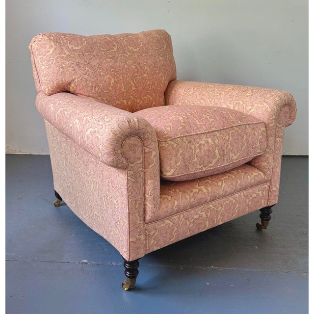 George Smith Full Scroll Arm Chair with looseback has down filled cushions and sits on turned mahogany legs with brass...