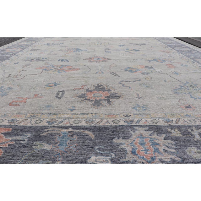Measures: 12'0 x 14'8 Modern Oushak Rug with Slate Blue Border and Colorful All-Over Tribal Motifs. Keivan Woven Arts /...
