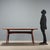 Italian-made dining table from the 1950s-1960s, featuring an exotic wood frame and a back-treated glass top, adding a...