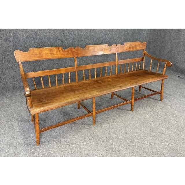 This 19th Century Solid Maple Bench features a beautifully aged patina, spindle back detailing, and a long, sturdy seat...
