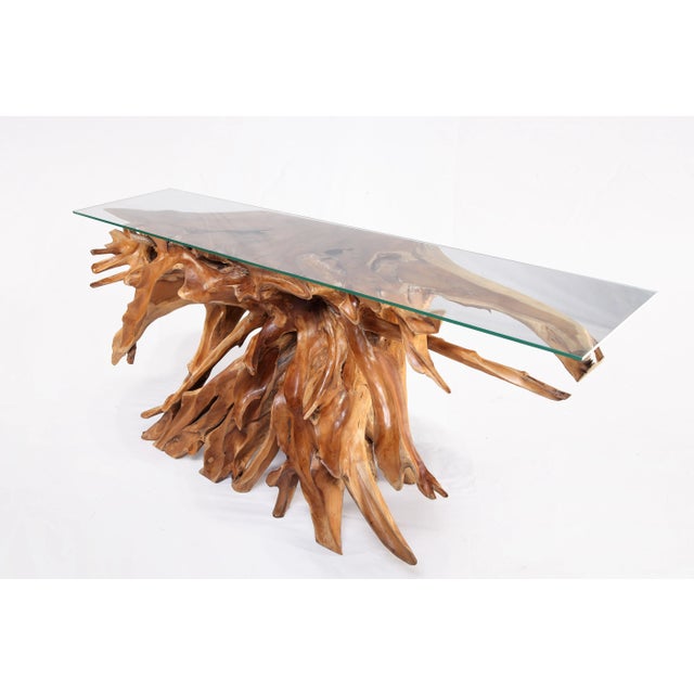 Inspired by the beauty of natural root form, this organic teak console table is handcrafted from one piece of salvaged...