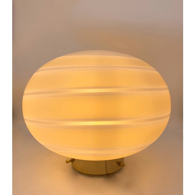 Fantastic designer ceiling light from around 1970, transparent glass. Metal and golden frame with a central E27 lamp...