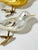 Set of three vintage glass bird Christmas ornaments featuring two golden birds and one pearly white bird. Each has...