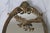 Vintage brass oval wall mirror featuring an ornate American Federal-style eagle motif across the upper center. Made in...