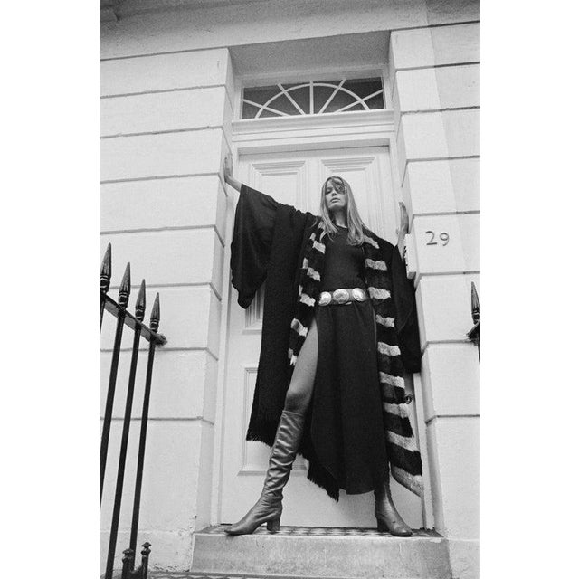 Veruschka von Lehndorff German model Veruschka von Lehndorff wearing an academic-style robe over a belted dress and boots,...
