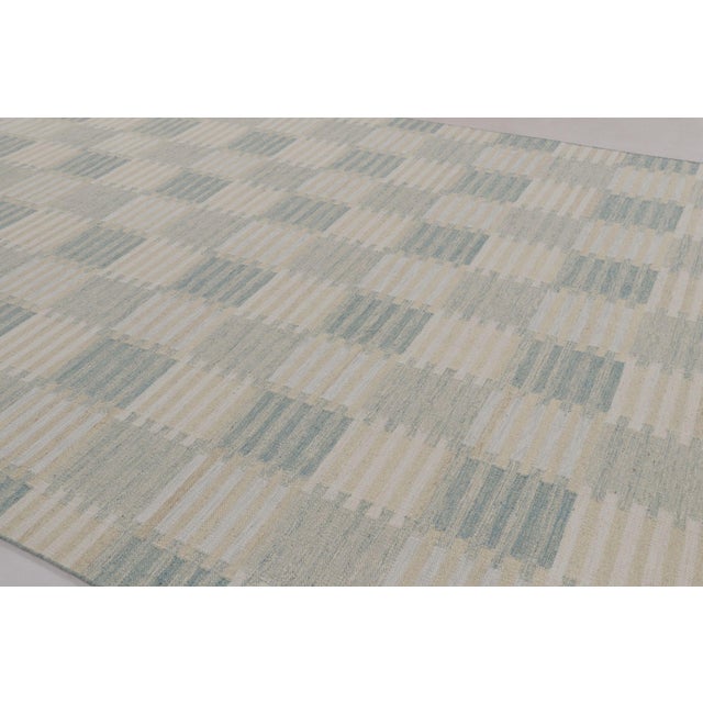 Handwoven in a blend of wool and undyed natural yarns, this 10x14 flatweave is from the contemporary works in Rug &...
