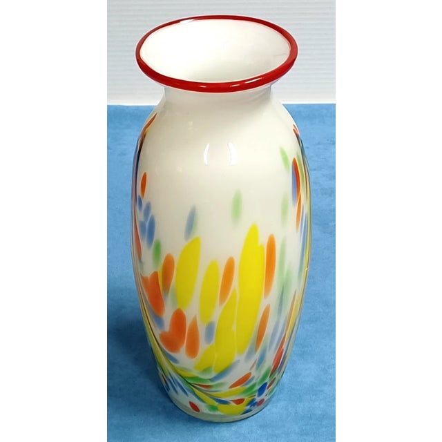 Stunning vintage Italian art glass vase featuring a vibrant confetti pattern and expertly hand-blown craftsmanship....