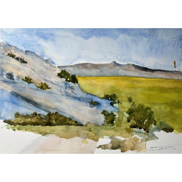 This watercolor depicts the rugged beauty of Split Rock in Wyoming, showcasing a harmonious blend of soft blues and earthy...