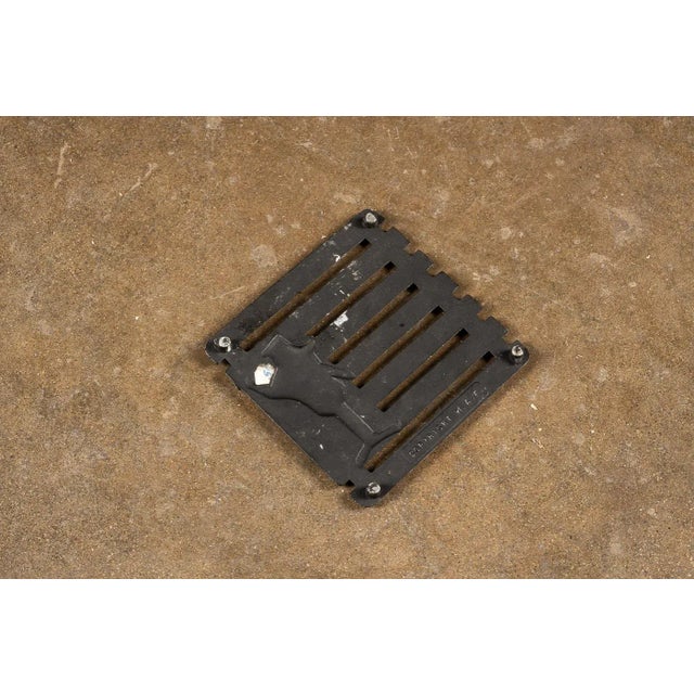 This mid century cast iron trivet was likely manufactured in the 1960s. This trivet measures 5"x5" and has four feet on...